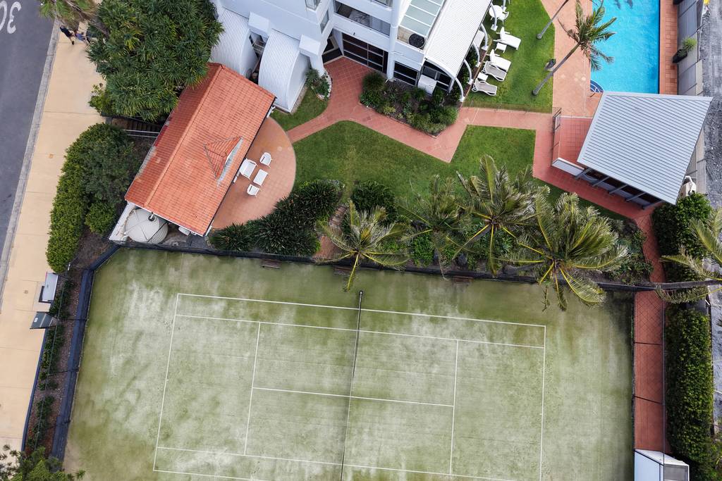 Pool and tennis court with landscaped grounds