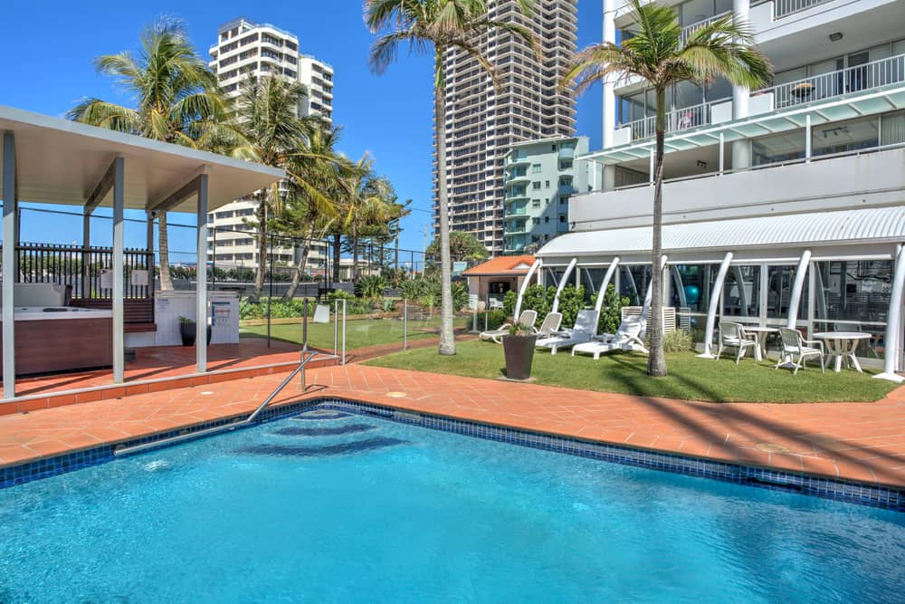 Heated saltwater pool at Marriner Views with loungers in landscaped gardens