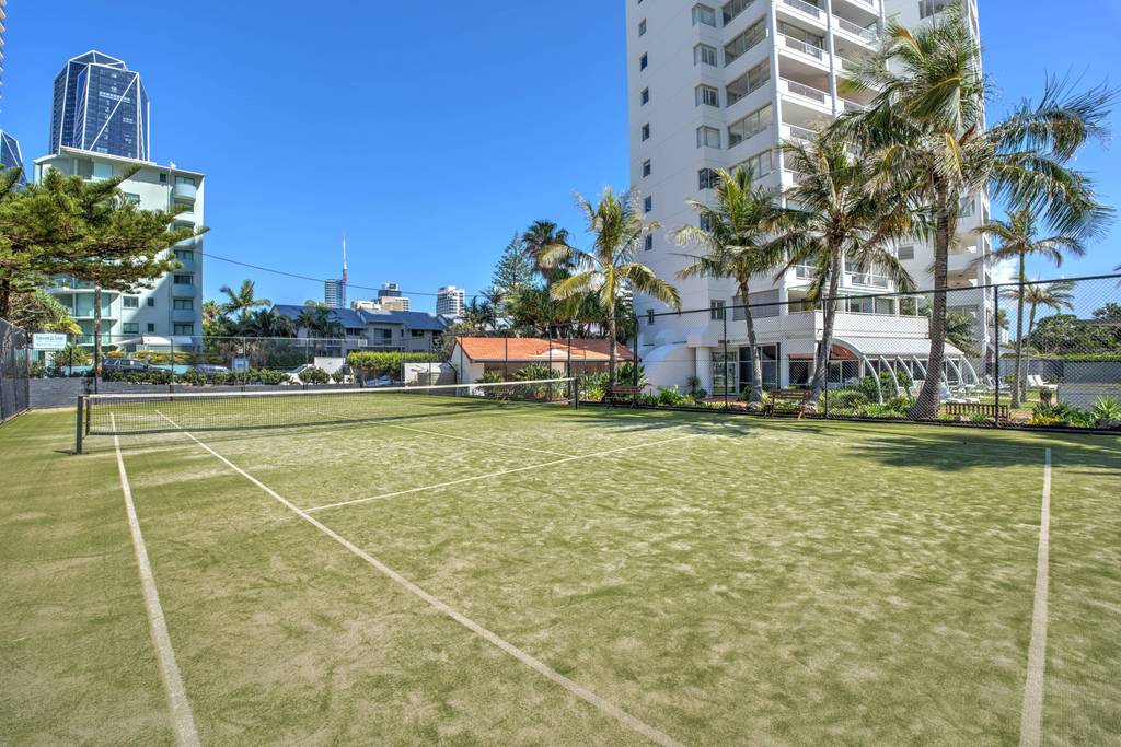Tennis court with surrounding gardens