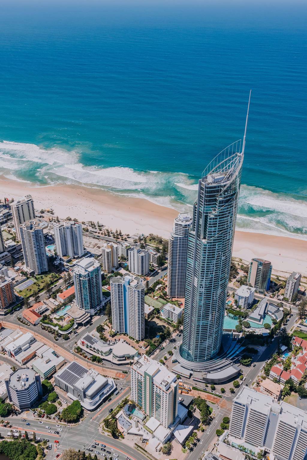 Surfers Paradise skyline at dusk seen from the beach to the south