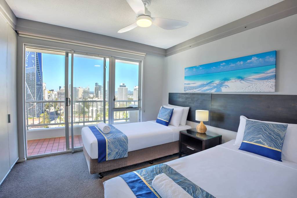 2 Bedroom Superior – twin bedroom with beach artwork